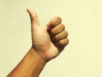 Close-up of human hand against white background