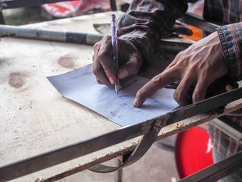 Cropped image of hands writing