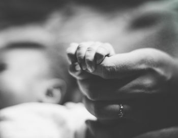Midsection of mother and daughter on hands