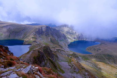 Scenic view of lake and mountains against sky