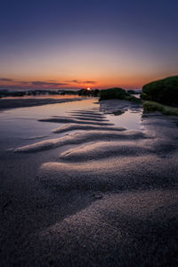 Scenic view of beach against sky during sunset