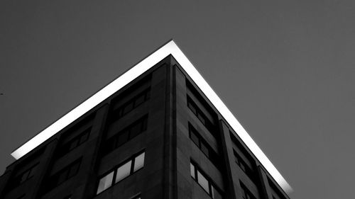 Low angle view of office building against clear sky