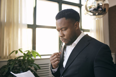 Side view of man using mobile phone