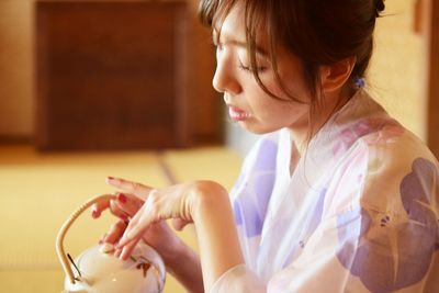 Portrait of woman holding kyusu