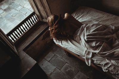 High angle view of woman relaxing on floor