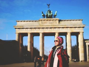 Woman standing against brandenburg gate