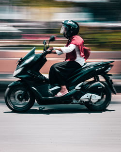 Side view of senior man riding motorcycle