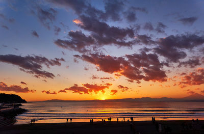 Scenic view of beach against sky during sunset