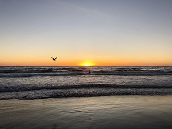 Scenic view of sea against clear sky during sunset