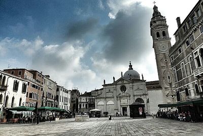 Facade of church against cloudy sky