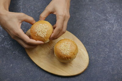 Close-up of person holding bread on table