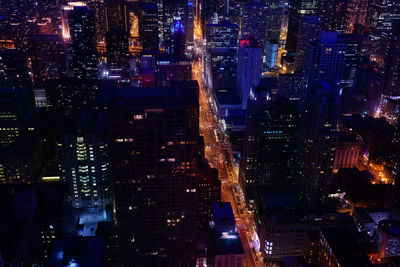 High angle view of illuminated city buildings at night