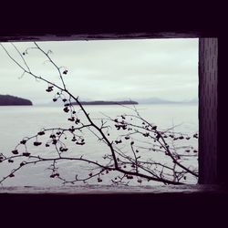 Scenic view of sea against sky seen through window