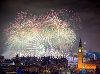 High angle view of firework display at night