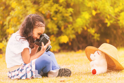 Woman photographing with toy camera