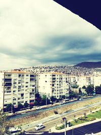 High angle view of cityscape against cloudy sky