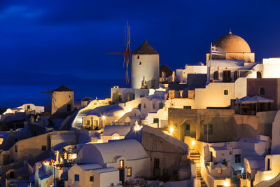 Houses against blue sky at dusk