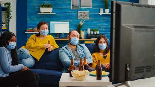 People wearing mask sitting at home