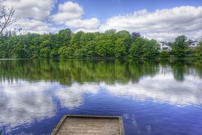 Reflection of trees in lake against sky