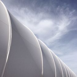 Low angle view of white built structure against sky