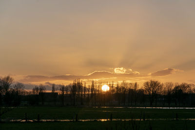 Scenic view of field against sky during sunset