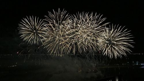 Low angle view of firework display at night