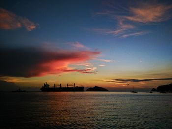 Silhouette ship sailing on sea against sky during sunset