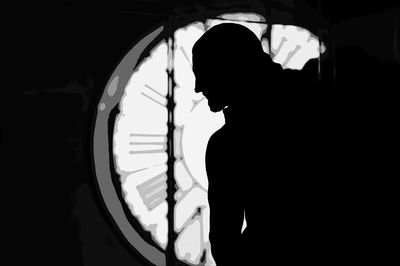 Portrait of silhouette woman standing in dark