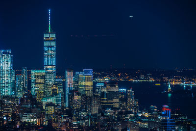 Illuminated cityscape against sky at night