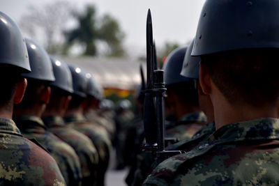 Rear view of army soldiers standing in row