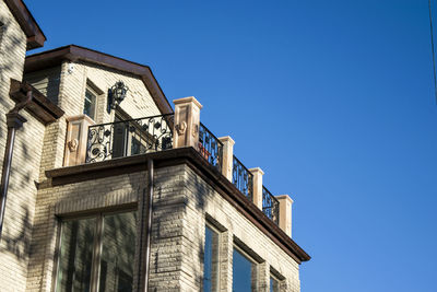 Low angle view of building against clear blue sky