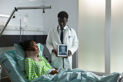 Doctor showing medical x-ray to patient