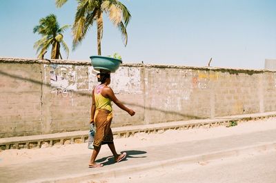 Woman with umbrella on palm tree