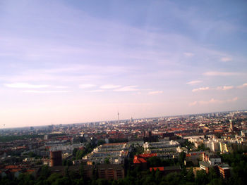 Cityscape against cloudy sky