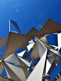 Low angle view of modern building against blue sky