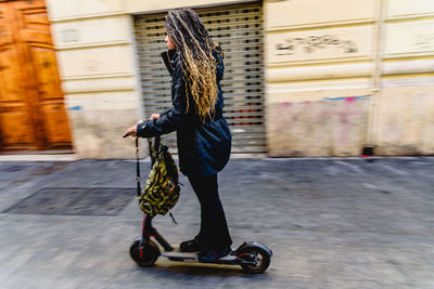 Man riding skateboard on street