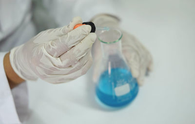 Cropped hands of female scientist experimenting in laboratory