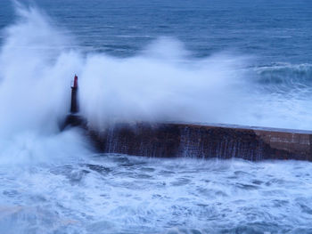 Sea waves splashing on pier