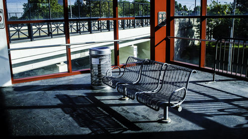 Empty bench on sidewalk