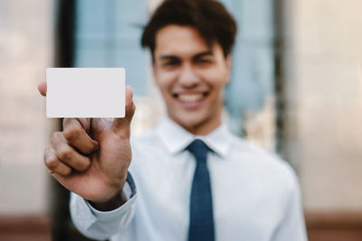 Portrait of man holding mobile phone