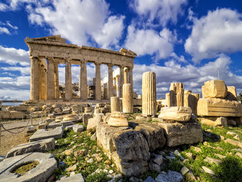 Ruins of temple against cloudy sky