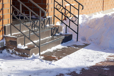 High angle view of staircase by snow covered building