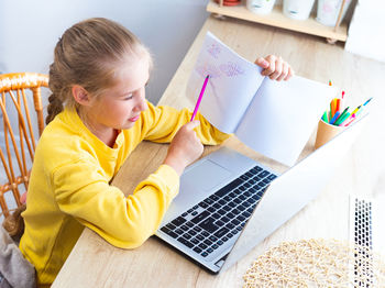 Boy using laptop at home