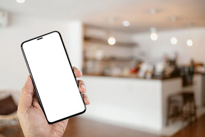 Low angle view of hand holding smart phone