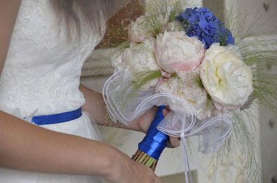 Close-up of woman holding bouquet