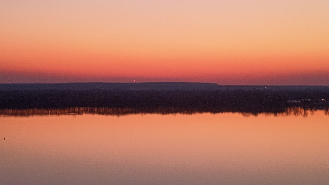 water, sunset, sky, dawn, beauty in nature, scenics - nature, tranquility, reflection, tranquil scene, orange color, horizon, lake, nature, afterglow, no people, idyllic, environment, landscape, red sky at morning, sun, evening, pink, non-urban scene, twilight, outdoors, horizon over water, copy space, silhouette, dramatic sky, romantic sky