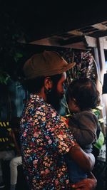 Rear view of couple holding hands