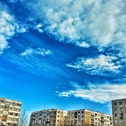 Low angle view of building against cloudy sky