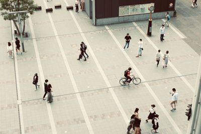 High angle view of people walking on city street