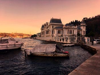 View of buildings at waterfront during sunset